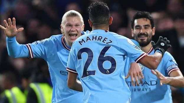 Man City players celebrate with Riyad Mahrez after he scores against Chelsea