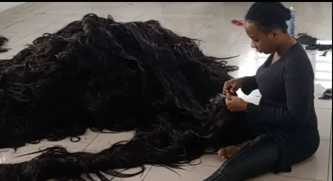 Helen Williams working on the wigs [TribuneOnline]