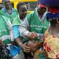 Health officers administering vaccine to infants during immunisation exercise in Nigeria