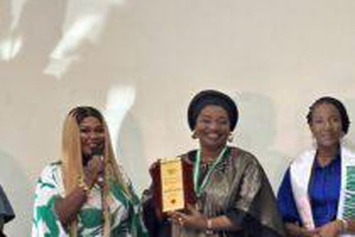 Hajiya Neemat Abdulrahim, Director, FCT Education Resource Centre, receiving her award. (Credit: NAN)