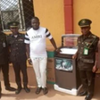 The ex-offender, Daniel Aturu with the Deputy Controller of Corrections, in charge of the Medium Security Custodial Centre, Owerri, Imo, Eke Eke and other senior staff of the Service [NAN]