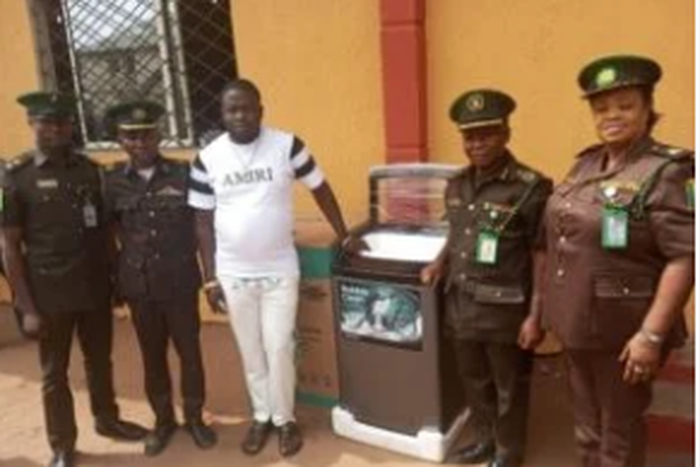 The ex-offender, Daniel Aturu with the Deputy Controller of Corrections, in charge of the Medium Security Custodial Centre, Owerri, Imo, Eke Eke and other senior staff of the Service [NAN]