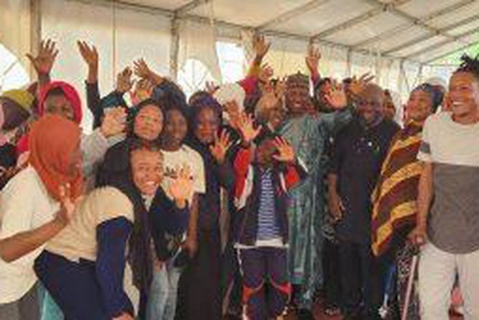 Amb. Kabiru Musa, Charge D’affaires en titre of the Nigerian Mission to Libya  flanked by some of the evacuees before departing Mitiga International Airport Tripoli on Tuesday. [NAN]