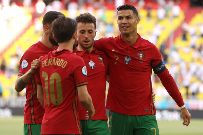 Cristiano Ronaldo of Portugal celebrates with Diogo Jota and Bernardo Silva after scoring their side's first goal during the UEFA Euro 2020 Championship Group F match between Portugal and Germany