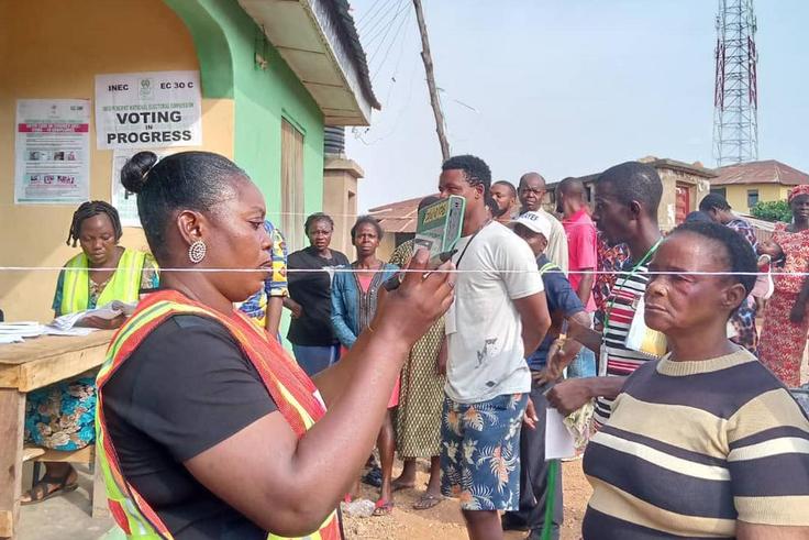 INEC officials attending to voters at a polling unit during the 2023 general elections. [Twitter:@inecnigeria]