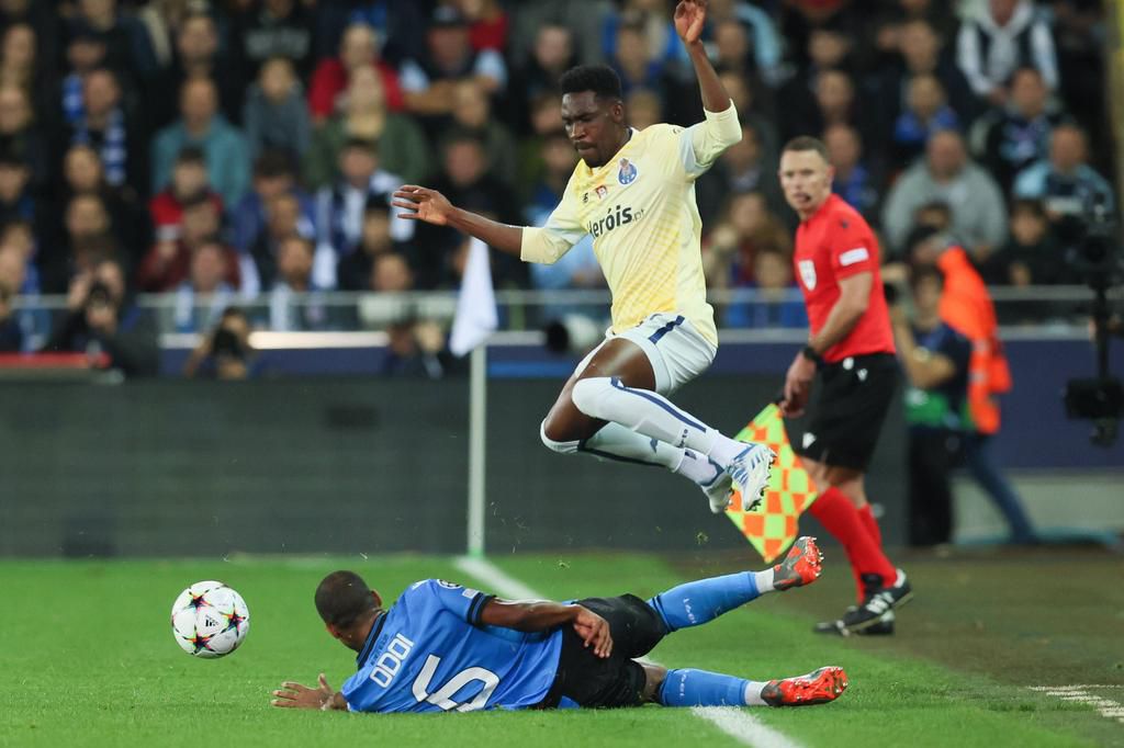 Club s Denis Odoi and Porto s Zaidu Sanusi fight for the ball during the match between Belgian soccer team Club Brugge KV and Portuguese FC Porto , Wednesday 26 October 2022 in Brugge, Belgium