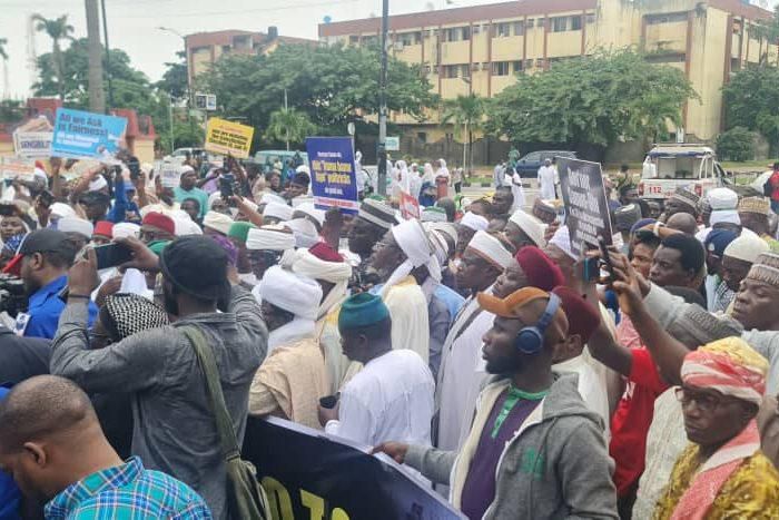 During the protest, participants displayed banners and placards adorned with slogans such as "Muslims Reject Official Discrimination," "Fairness is All We Seek," and "Halt the Screening Now, We Demand Justice" [Twitter]