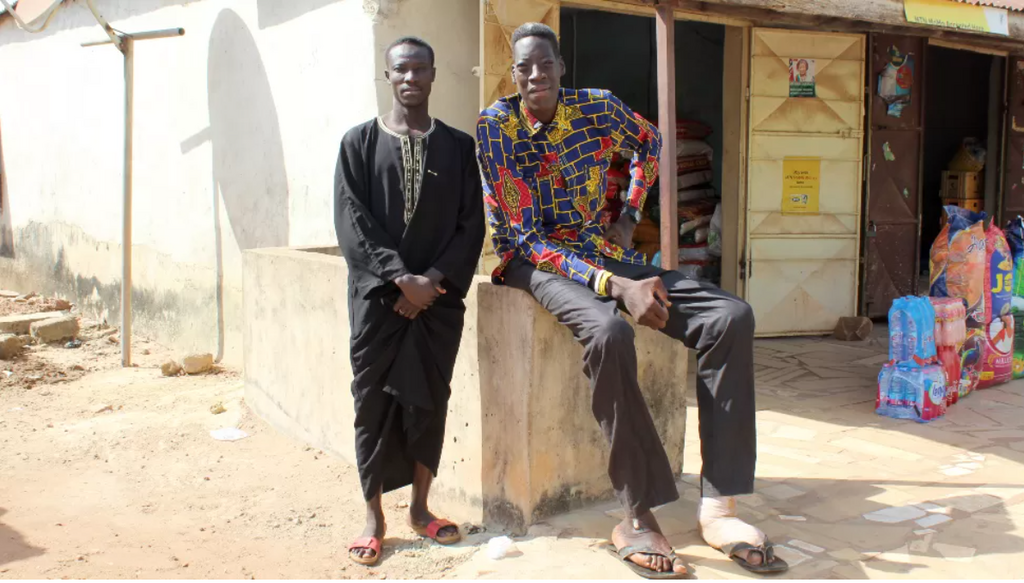 Awuche now lives with his older brother (L) in Gambaga