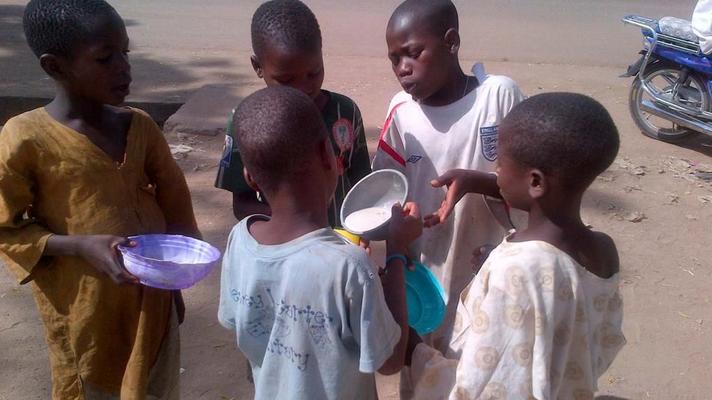 Almajiri children sharing food in the North