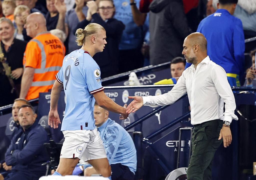 Manchester City manager Pep Guardiola brings off Erling Haaland of Manchester City in the second after his second home hat trick in just four days, at the Etihad on August 31, 2022.