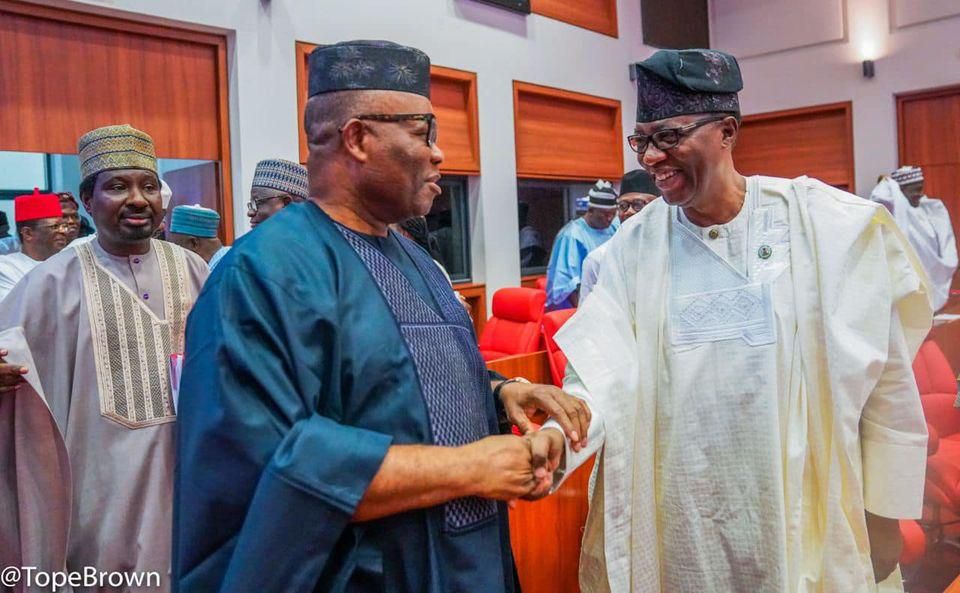 Senate President Godswill Akpabio (left) shakes hands with Senator Gbenga Daniel (right) [Tope Brown]