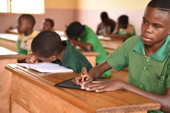 Visually impaired student learning in class room with other students [CBM]