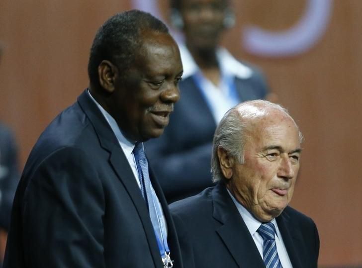 Issa Hayatou (L), Senior Vice President of the FIFA stands with FIFA President Sepp Blatter after he was re-elected at the 65th FIFA Congress in Zurich, Switzerland, May 29, 2015.
