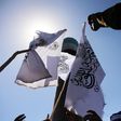 Taliban fighters stand next to Taliban flag on August 31, 2022.Bilal Guler/Anadolu Agency via Getty Images