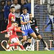Nigeria's Zaidu Sanusi (second-right) watches on as Rafa Silva (left) shoots to score for Benfica against FC Porto