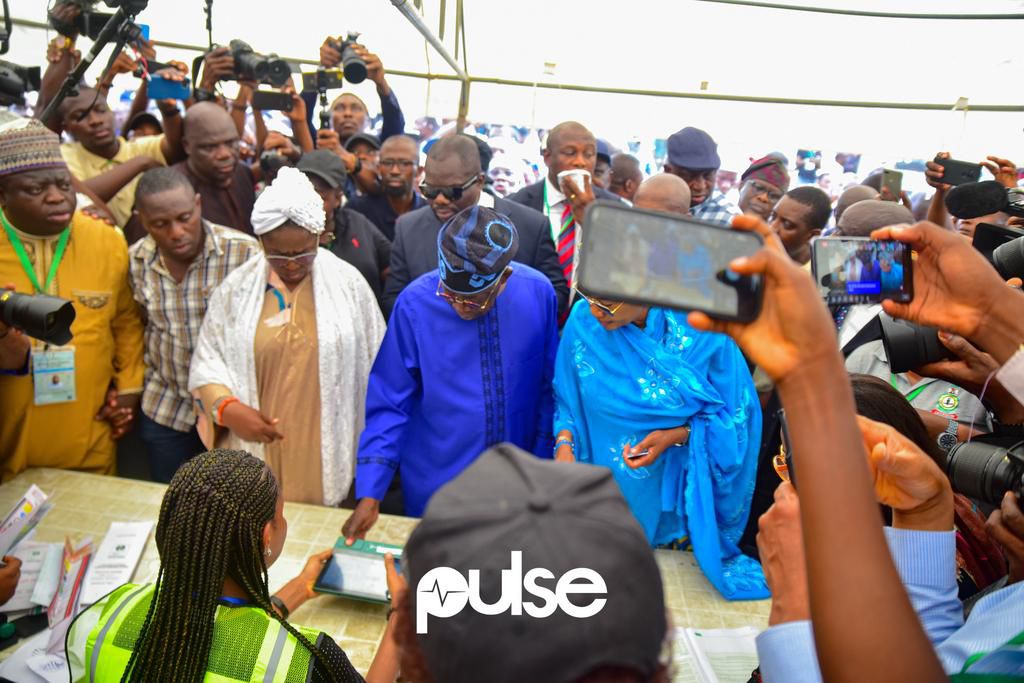 Bola Tinubu (in blue) voting at his polling unit in Lagos State