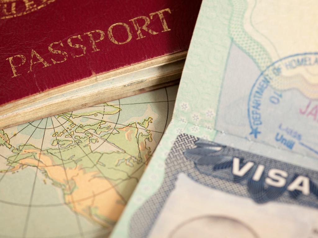 A vintage US map, passport and visa.belterz/Getty Images