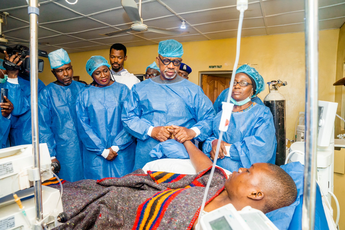 Gov. Dapo Abiodun holding the victim in Intensive Care Unit at Federal Medical Centre, Abeokuta. [Twitter:@dabiodunMFR