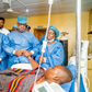 Gov. Dapo Abiodun holding the victim in Intensive Care Unit at Federal Medical Centre, Abeokuta. [Twitter:@dabiodunMFR