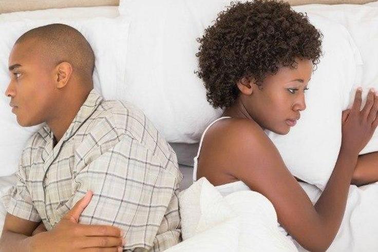 Estranged couple in bed