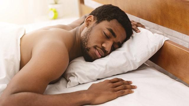 Opt for a softer pillow to reduce strain on your neck [Adobe Stock]