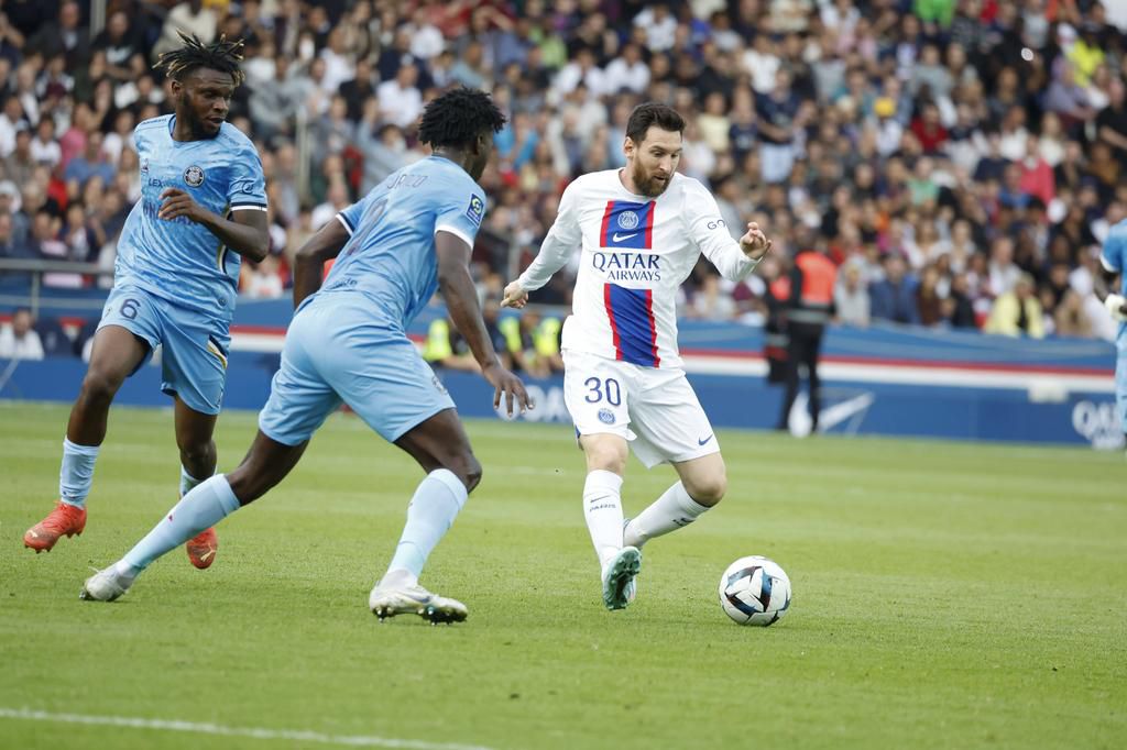 Paris Saint-Germain's Lionel Messi (R) breaks through during the French League 1 football match between Paris-Saint Germain (PSG) and Troyes at Parc de Prines in Paris on October 29, 2022.