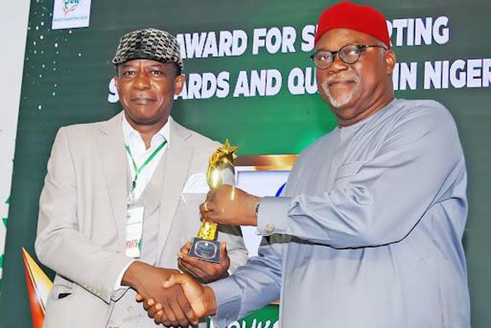 L-R: Femi Fapohunda, Managing  Director, Mouka Limited receiving his special recognition award of Excellence from Barrister Osita Anthony Aboloma, Former Director-General of the Standards Organisation of Nigeria (SON).