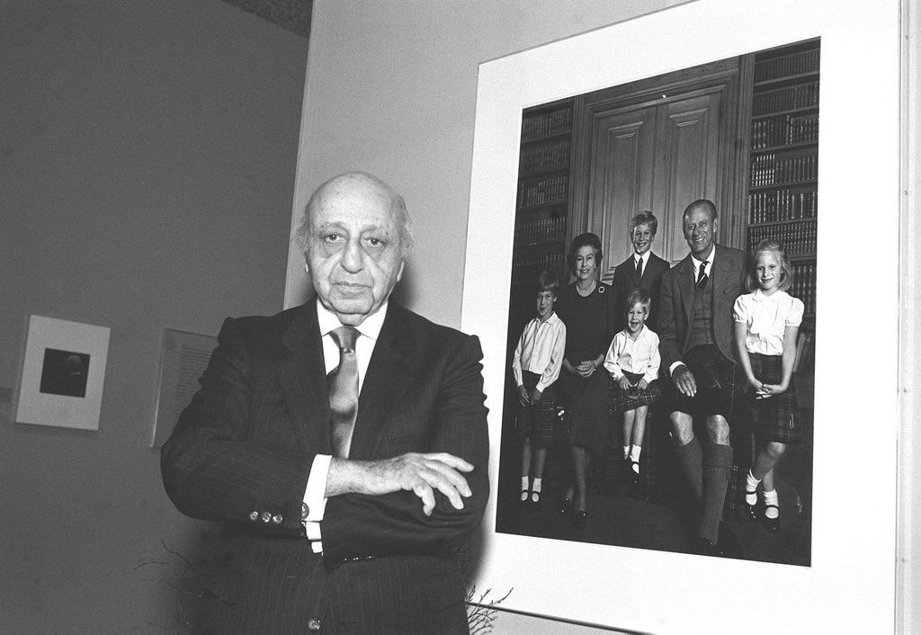 1987: Photographer Yousuf Karsh stands next to this portrait of the Queen and her grandchildren. The image appeared on their 1987 Christmas card.