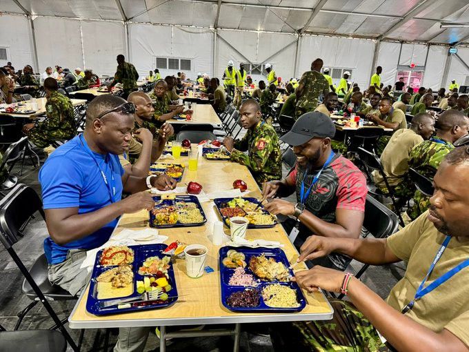 Larry Madowo having lunch with Kenyan police in Haiti