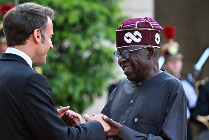 French President Emmanuel Macron (L) greets Nigeria's President Bola Tinubu (R) upon arrival for an official dinner at the Elysee Palace, on the sidelines of the New Global Financial Pact Summit in Paris, France on June 22, 2023. [Getty Images]