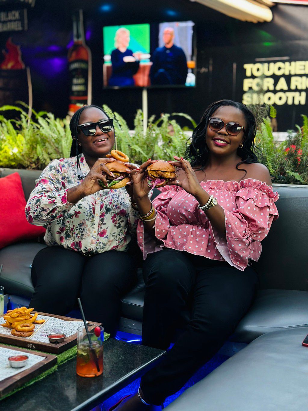 Two people enjoying burgers
