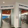 An AI-generated image of an Interior of a modern gym featuring separate workout rooms for men and women The gym is split into two distinct areas