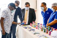 Olusegun Obasanjo looking at Ugandan milk products