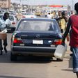 Black market fuel vendors tries to sell fuel to a motorist on Lagos-Ikorodu highway 17 June 2007. [Getty Images]