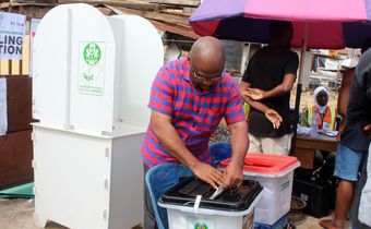 A voter at a polling unit cast his vote. [Getty Images]