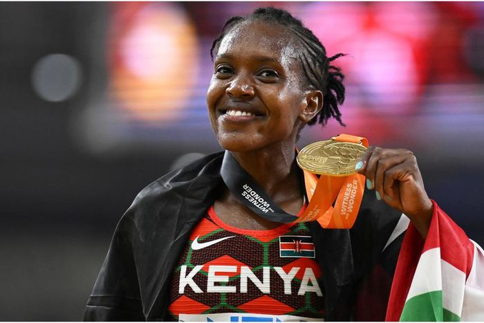 Faith Kipyegon shows off her Gold Medal during a past competition