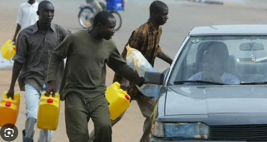 Fuel peddlers hawking petrol in jerrycans in Abuja. [Nairametrics]