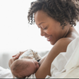 A mother breastfeeding her child [YES! Magazine]