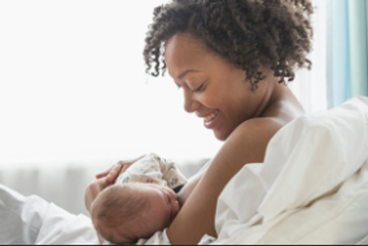 A mother breastfeeding her child [YES! Magazine]