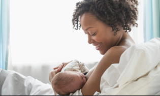 A mother breastfeeding her child [YES! Magazine]