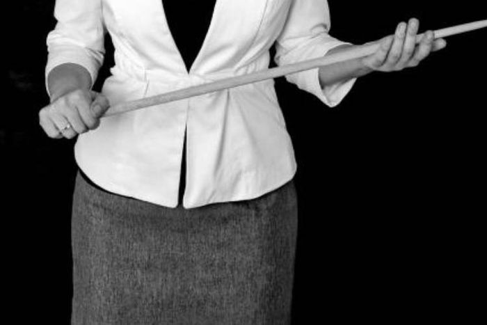A teacher holding a cane