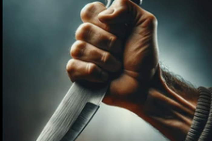 Hand holding a knife [Shutterstock]