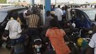 People queue to buy fuel at a petrol station in Lagos, southwest Nigeria. [Getty Images]