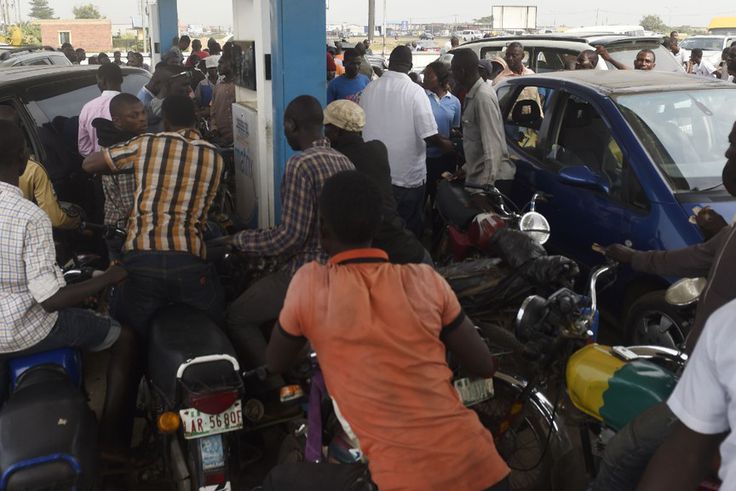 People queue to buy fuel at a petrol station in Lagos, southwest Nigeria. [Getty Images]
