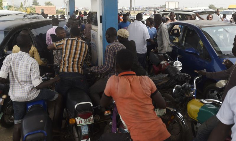 People queue to buy fuel at a petrol station in Lagos, southwest Nigeria. [Getty Images]