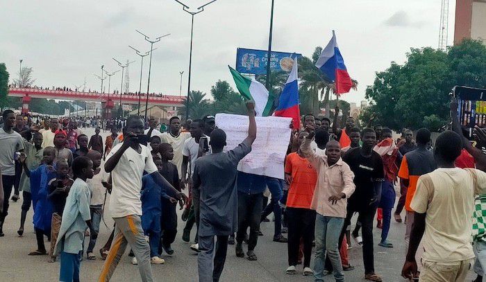Protesters raise the Russian flag in Kano. [Arise TV]