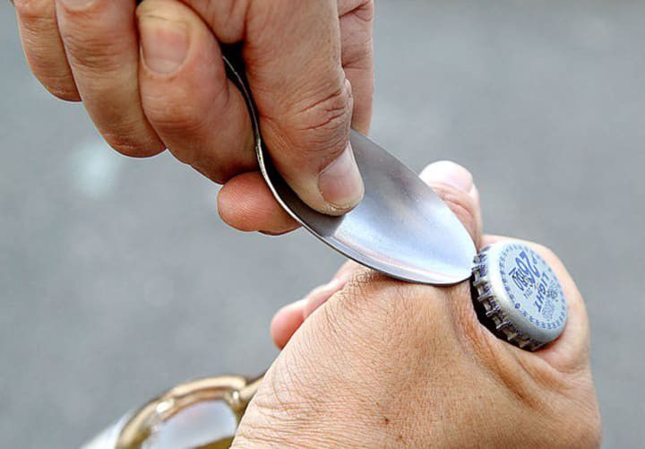 Opening a bottle with a spoon