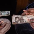 A customer exchanges Nigerian 1000 Naira banknotes for US dollar banknotes with a street currency dealer at a market in Lagos, Nigeria, on Monday, Sept. 25, 2023.  [Getty Images]