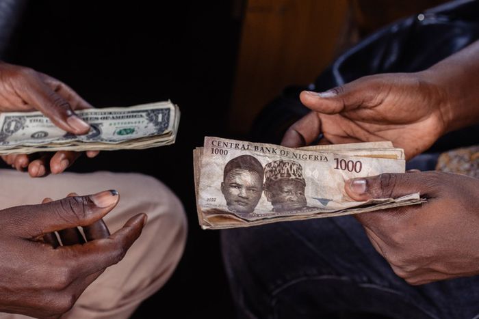 A customer exchanges Nigerian 1000 Naira banknotes for US dollar banknotes with a street currency dealer at a market in Lagos, Nigeria, on Monday, Sept. 25, 2023.  [Getty Images]