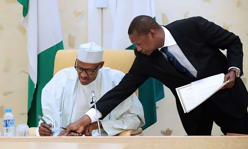 L-R: Former President Muhammadu Buhari and former AGF Abubakar Malami. [PremiumTimes]